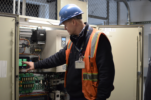 Chris Pedersen checks out the control room for the new elevators at the Isaac Houses’ 1830 First Avenue building. | JACKSON CHEN 