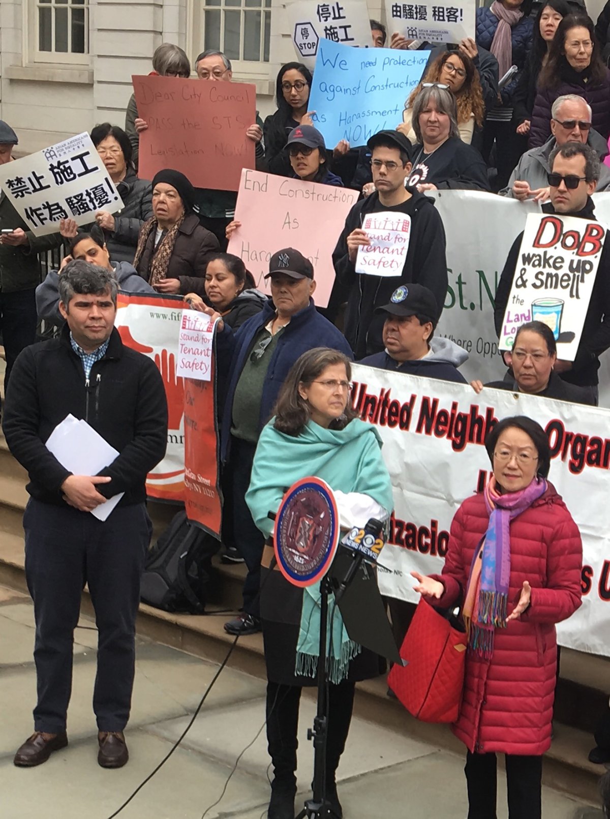Margaret Chin, front row right, and Helen Rosenthal, to the left of her, were among the councilmembers at a City Hall rally last week calling for speedy passage of the S.T.S. package of anti-harassment bills. At left is Rolando Guzmán of Brooklyn’s St. Nick’s Alliance. Photo by Joaquin Cotler