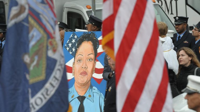 A portrait of slain FDNY EMT Yadira Arroyo is part of the funeral pageantry Saturday, March 25, 2017, outside St. Nicholas of Tolentine Roman Catholic Church on University Avenue in the Bronx.