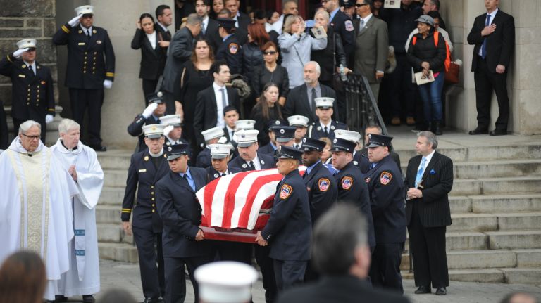 The coffin of FDNY EMT Yadira Arroyo is carried from St. Nicholas of Tolentine Roman Catholic Church on Saturday, March 25, 2017, after her funeral.