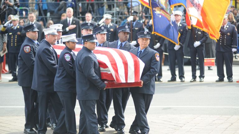 A funeral for FDNY EMT Yadira Arroyo was Saturday, March 25, 2017, at St. Nicholas of Tolentine Roman Catholic Church on University Avenue in the Bronx. Above, Arroyo's coffin is carried into the church.