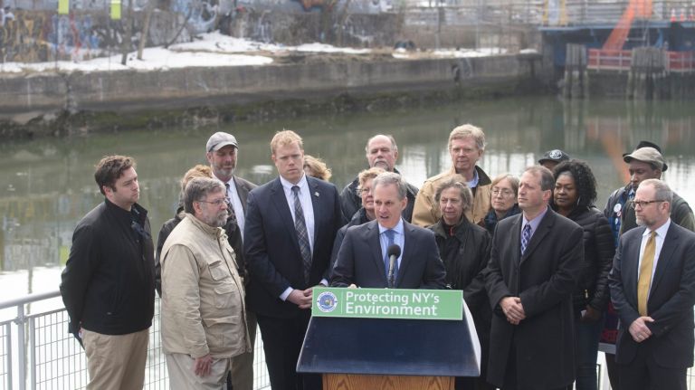 New York Attorney General Eric Schneiderman, center, is joined by local politicians, environmental activists and community members as he highlights the effects of cuts to the EPA during a news conference next to the Gowanus Canal  in Brooklyn on Tuesday, March 21, 2017.