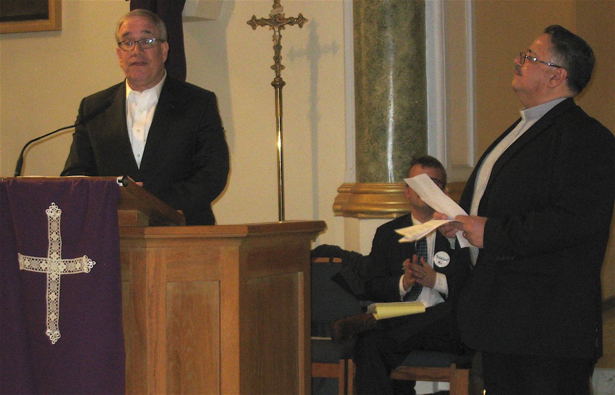 Father Thomas Faiola, pastor of Our Lady of Sorrows, looked on as Comptroller Scott Stringer made his remarks at the Manhattan Together gathering. Photo by Lesley Sussman