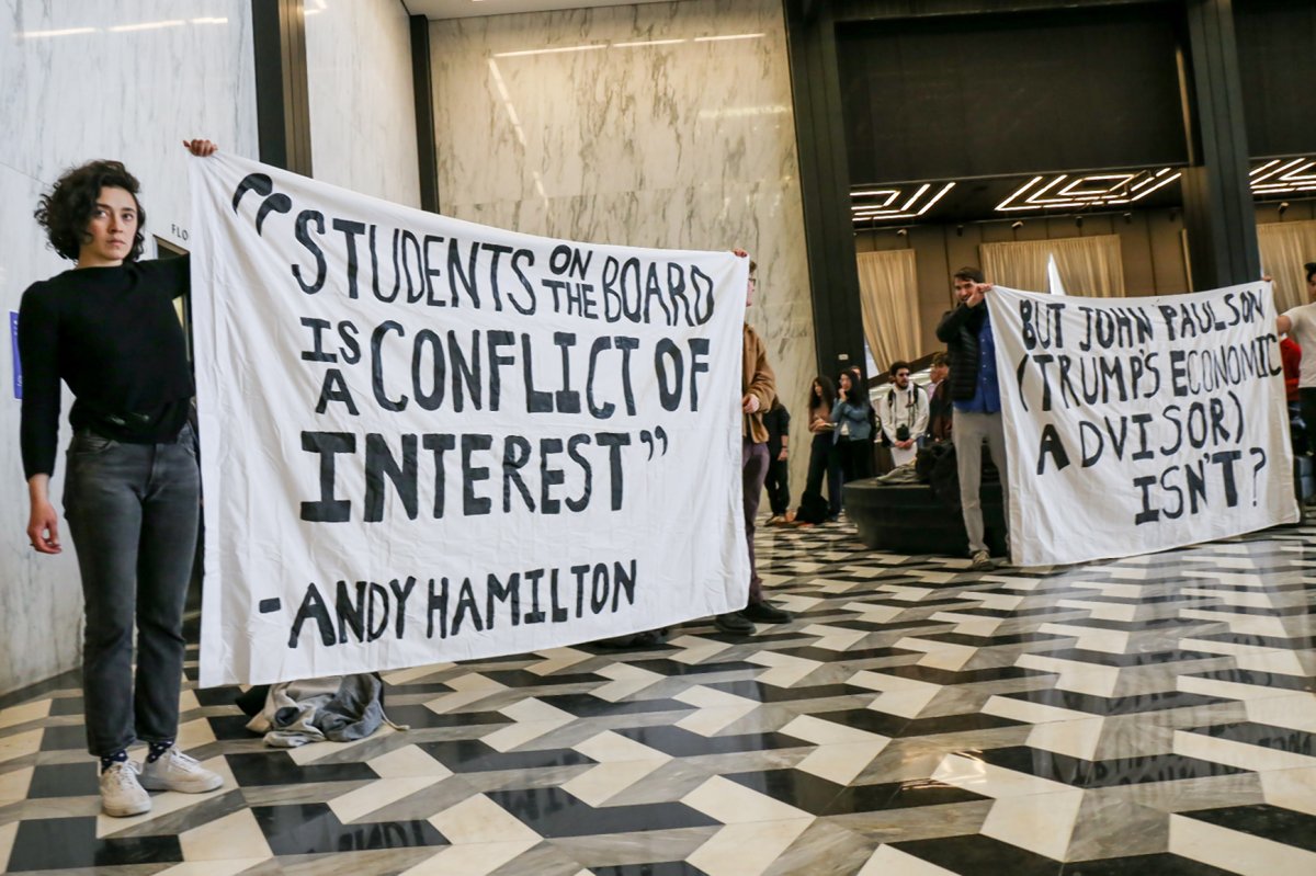 Members of the N.Y.U. activist group SLAM and others briefly occupied the lobby of N.Y.U. Bobst Library on Washington Square South last Wednesday. They demanded to meet with the university’s president, Andrew Hamilton, about their objection to John Paulson, a member of Donald Trump’s economic advisory team, being on the school’s board of trustees and also about the idea of having student members on the board.  Photo by Tequila Minsky