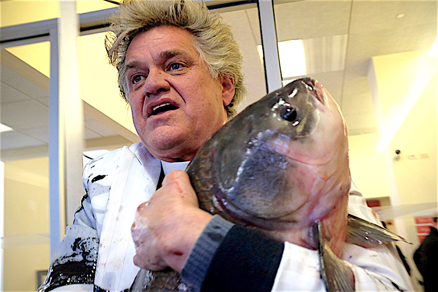 Reverend Billy and the carp, which was rushed to the East River.