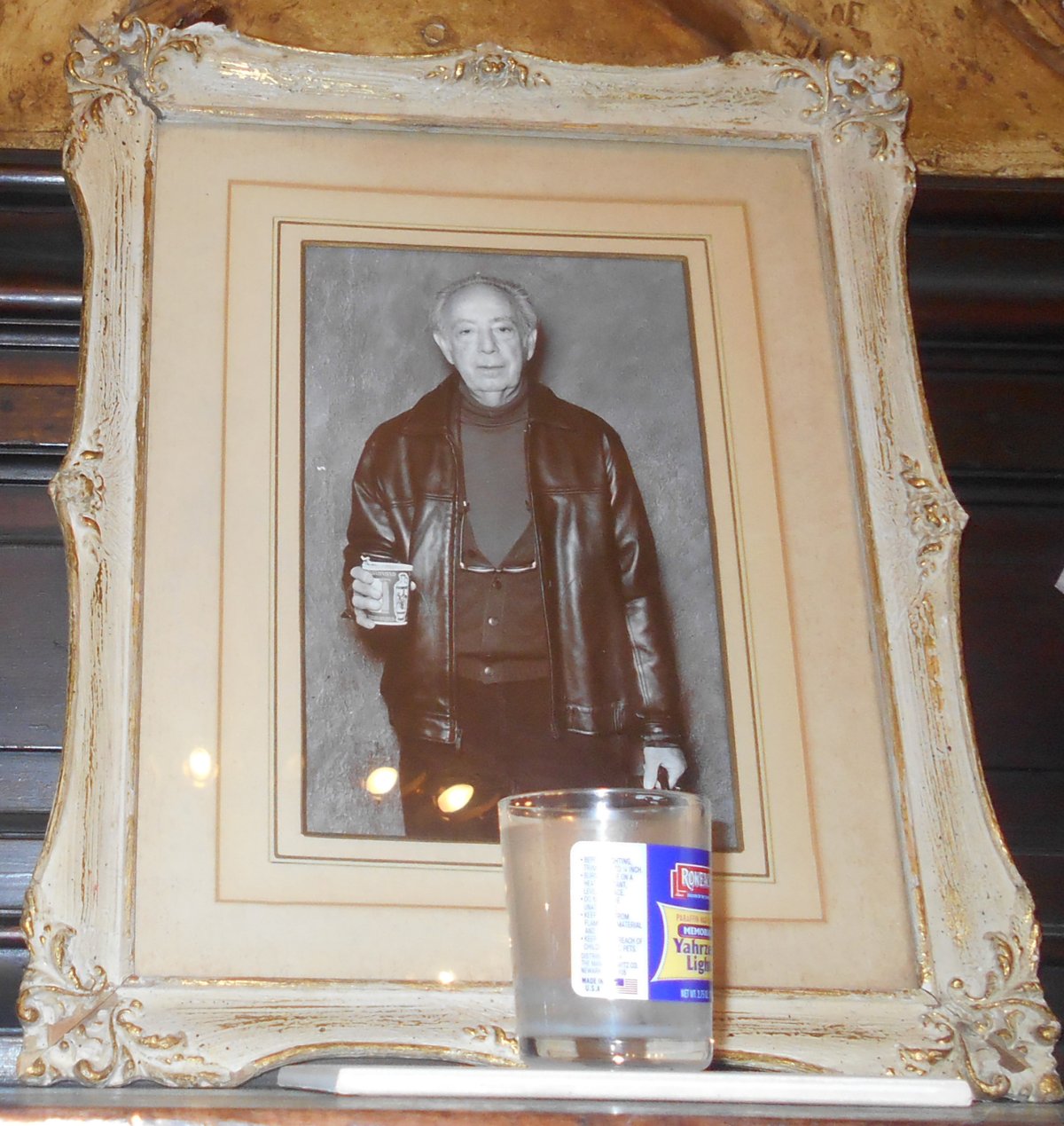 A photo of Stanley Bard, The Chelsea Hotel’s former owner, and memorial candle that were left atop the hotel lobby’s fireplace after he died last month. Photo by Mary Reinholz