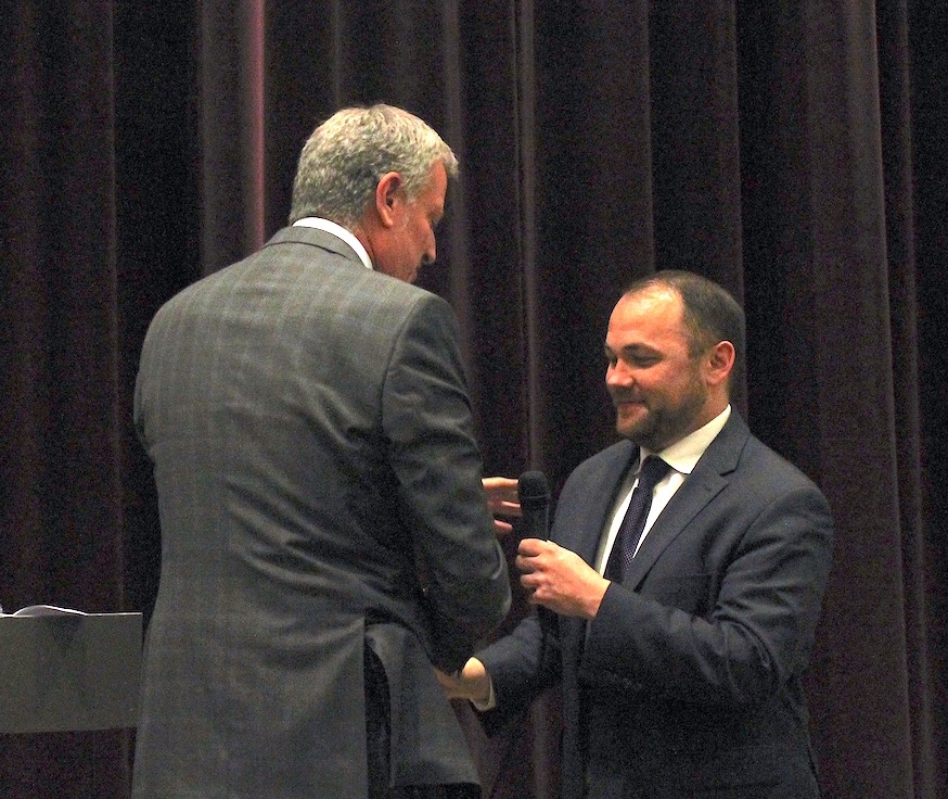 Councilmember Corey Johnson shook hands with the mayor and passed him the microphone after introducing him at the local political clubs' candidates night. Photo by Lincoln Anderson