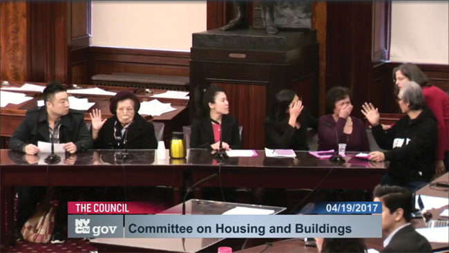 Councilmember Helen Rosenthal (at right) came to comfort longtime Eldridge St. resident Xiao Ling Chen (third from right), who began to cry before delivering testimony chronicling her family’s harassment. Screen grab image via council.nyc.gov/live. 