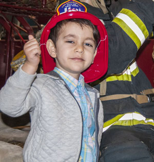 Photo by Tony Falcone Three-year-old Nikola Gazahi got a cool fire hat along with some eggs at the Fire Museum’s Easter celebration.