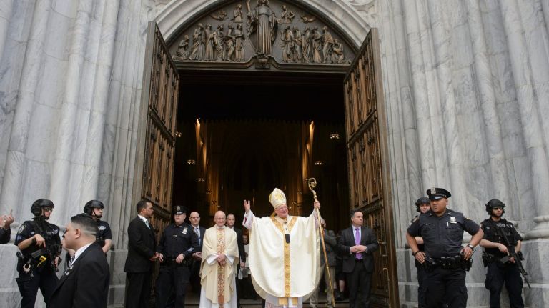 Cardinal Timothy Dolan waves to the crowd on Fifth Avenue during the Easter Parade and Bonnet Festival in Manhattan  on Sunday, April 16, 2017.   
