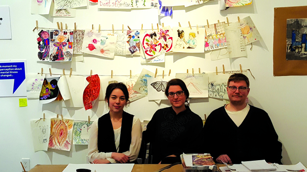 Vanessa Smith, project manager of New York City Mural Arts Project, Ariel Willmott, director of Fountain House Gallery, and Andrew Frank Baer, lead muralist, in front of artwork by members of the Hell’s Kitchen community. | DUSICA SUE MALESEVIC  