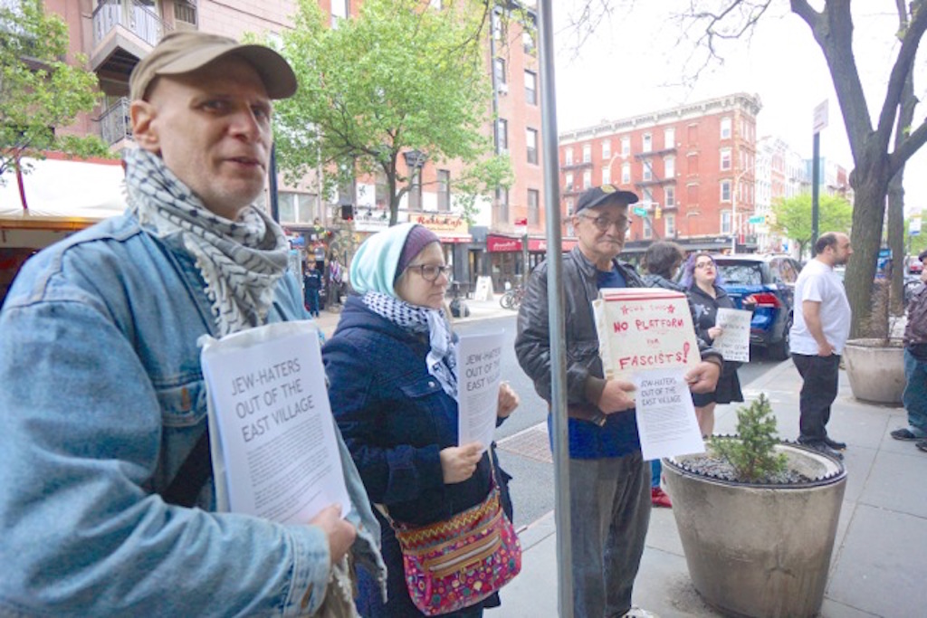 Left-wing journalist Bill Weinberg, at far left, and a handful of others protested outside Theatre 80 last Sunday afternoon, saying Gilad Atzamon should not have been given a platform to speak in the East Village. Photos by Sarah Ferguson 