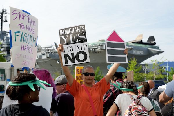 New York's Thumbs Down on President's Homecoming 1 A protester marching with Rise and Resist and Gays Against Guns near 44th Street and 12th Avenue, a couple of blocks below the Intrepid. | DONNA ACETO