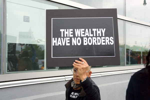New York's Thumbs Down on President's Homecoming 7 Another protester focused on the Trump administration's tilt toward the wealthy. | DONNA ACETO