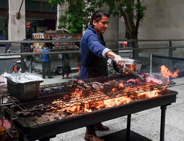Leaping flames to grill the steak for Bavaria Bier Haus’ sandwiches.