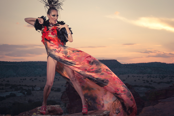 A cape, dress, and headdress from the “Desert Heat Collection” (2012) by Orlando Dugi, of Diné (Navajo) heritage, with paint, silk, organza, feathers, beads, and 24k gold and headgear of feathers and porcupine quills. Julia Foster is the model, with hair and makeup by Dina DeVore. | UNÉK FRANCIS/ COURTESY OF THE DESIGNER 