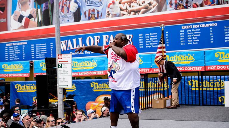 Nathan's Hot Dog Eating Contest 2017: Photos from the Coney Island event 18 Rappper Eric Badlands Booker, who also competed, entertains the crowd at the Nathan's Annual Hot Dog Eating Competition in Coney Island, Tuesday, July 4, 2017.