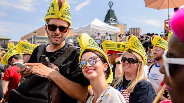 Nathan's Hot Dog Eating Contest 2017: Photos from the Coney Island event 20 Spectators wearing hotdog hats cheer on the competitores at the Nathan's Annual Hot Dog Eating Competition in Coney Island, Tuesday, July 4, 2017.