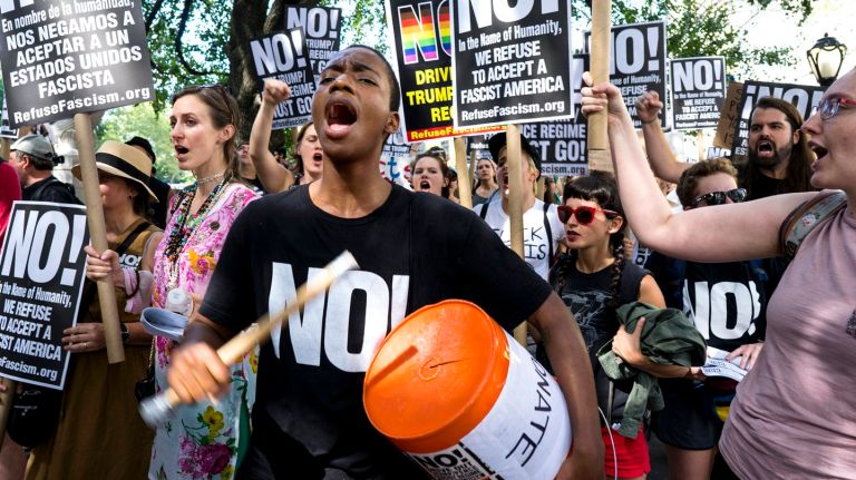 Anti-Trump protesters gather near Trump Tower on Sunday, Aug. 13, 2017, in reaction to the president's response to violence that erupted in Charlottesville, Virginia over the weekend.