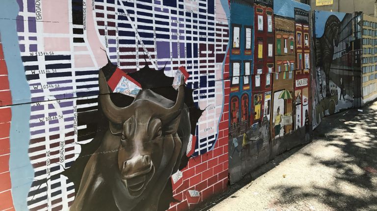 A group of artists is taking a stand against gentrification with a mural on an East Harlem fence.