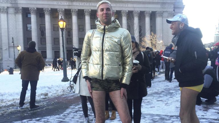 Kamil Brazet, left, and Bartek Hills, right, of Brooklyn get ready to participate in the pants off subway ride on Sunday, Jan. 7, 2018.