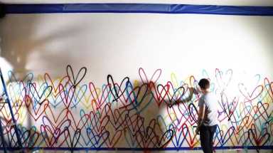 James Goldcrown paints his famous ‘Bleeding Hearts’ mural at Dream Downtown