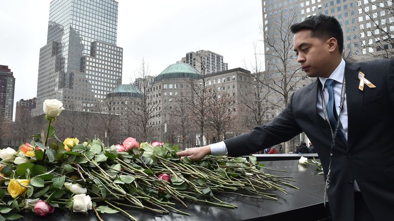 World Trade Center 1993 bombing victims honored at ceremony 25 years later 3 A mourner places flowers during the ceremony commemorating the 25th anniversary of the 1993 World Trade Center bombing at the The National September 11 Memorial & Museum in New York, on Feb. 26, 2018.