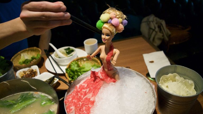 Meat Barbie was slowly stripped of her clothing.