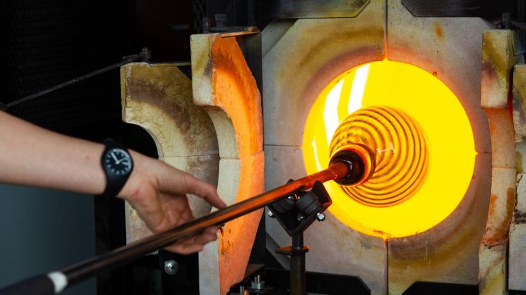 Glass is repeatedly returned to a reheating furnace which is 2200 degrees Fahrenheit aboad the launch of GlassBarge, a mobile glass blowing studio on a canal barge, at Pier 5 in Brooklyn, Thursday, May 17, 2018.