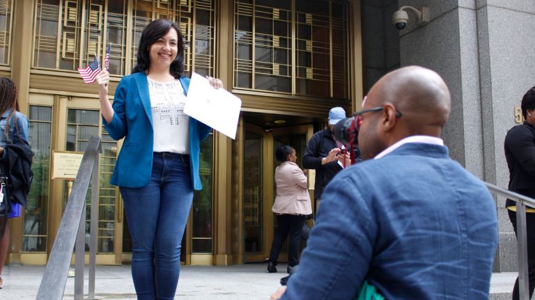 Becoming a U.S. citizen: Immigrant New Yorkers reveal why they want to become Americans 2 Anna Browning, from Moscow, Russia, poses for her husband outside the Daniel Patrick Moynihan United States Courthouse at 500 Pearl St. with her naturalization certificate on Friday, June 1, 2018.