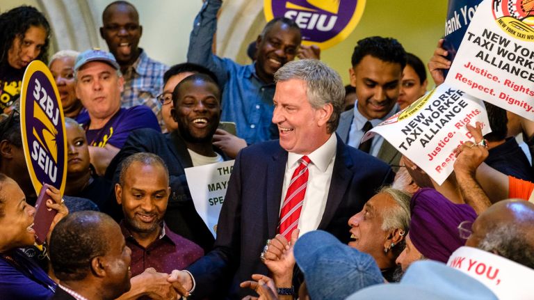 E-hail bill, putting cap on Uber, Lyft licenses, is now NYC law 2 A city cap on the ride-hailing car service industry -- the first of its kind in the nation -- was signed into law on Tuesday. After the signing, Mayor de Blasio is greeted by members of the New York Taxi Workers Alliance at City Hall.