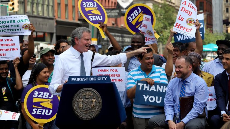 Mayor Bill de Blasio celebrates the passage of  for-hire vehicle industry regulation at Union Square on Thursday. 
