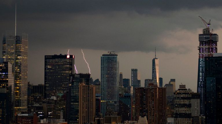 Storm clouds swirl over Manhattan on Tuesday. In Queens, three men were struck by lightning during the severe weather.