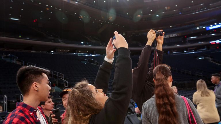 Visitors take pictures courtside during the new All-Access Tour at Madison Square Garden.