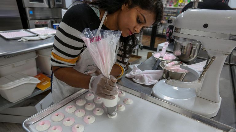 NY Cake, baking shop go-to, debuts bigger location in Flatiron 4 Teaching assistant Sheila Muthaiyan makes French macarons at NY Cake, which has expanded its class offerings at its new location.