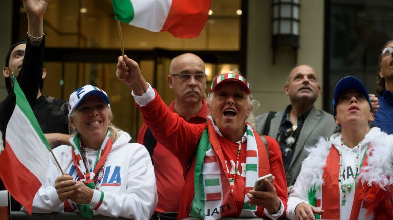 At the annual Columbus Day Parade in Manhattan, spectators cheer along Fifth Avenue as marching bands, floats and dancers pass by.