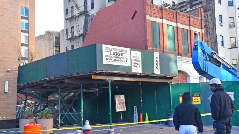 The rear portion of the building on West 135th Street collapsed around 11:50 a.m., officials said.