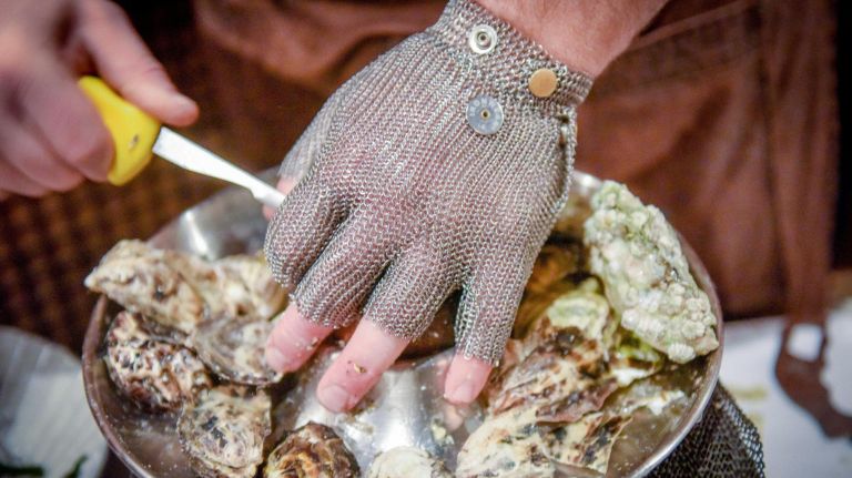 McMurray wears a chain mail glove when shucking, but you can use a tea towel, too.