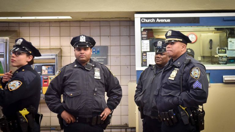 NYPD officers patrol the Church Avenue subway station on Monday following the attack on&nbsp;Ann Marie Washington.