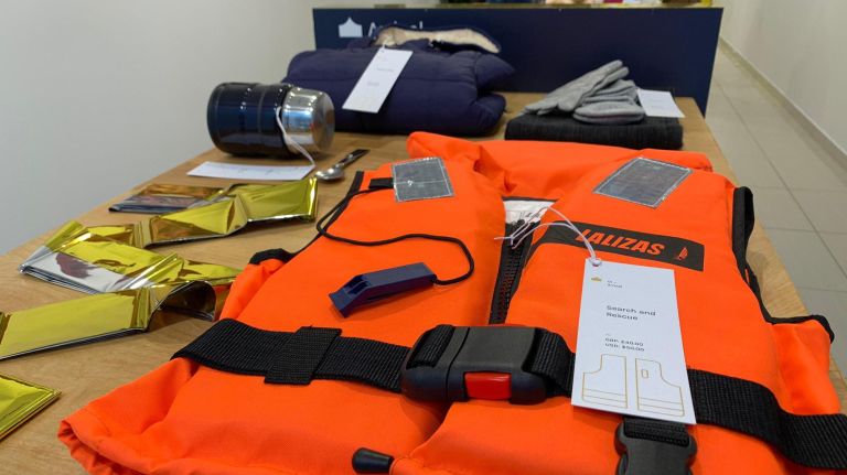Choose Love in SoHo takes on world refugee crisis by turning 'consumerism on its head' 3 Items like a life jacket, a heating blanket, a canister of food and warm winter essentials are at the "Arrival" table.
