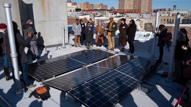 Advocates speak at a news conference about the solar panel installation on a co-op in Harlem on Wednesday.