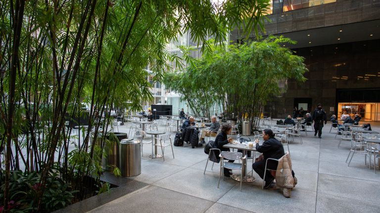 People enjoy the privately-owned public space at 590 Madison Ave.