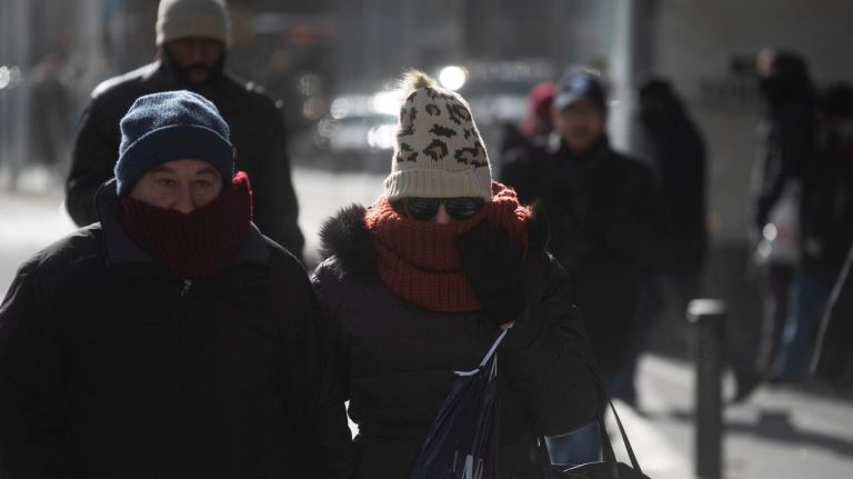 NYC weather: After coldest day of the season, warmer temps on the way 3 Bundled-up people brave the cold as they walk along Sixth Avenue in Manhattan on Monday.