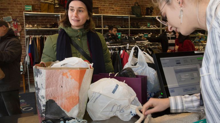 Anna Gonick, left, of Sunnyside, sells her clothes at Buffalo Exchange. Haris Erpelding, right, checks things out&nbsp;at the Astoria shop. Some New Yorkers looking to declutter their homes have been inspired&nbsp;by Marie Kondo's Netflix show "Tidying Up."