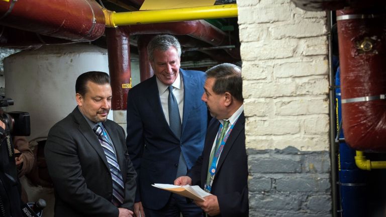 Mayor Bill de Blasio, center, visits a heating plant at NYCHA's Lower East Side Rehab Houses in October 2018.