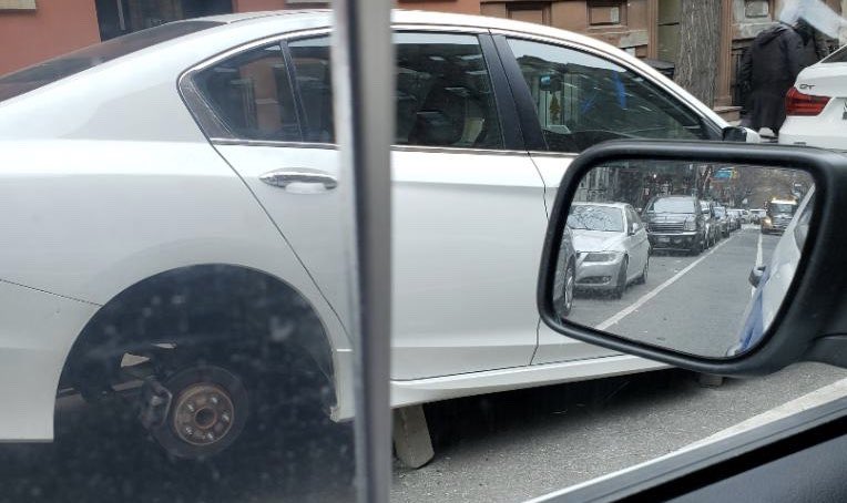 New jack city: U.E.S. car stripped of wheels 1