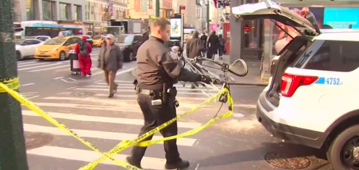 Officer taking away the mangled bicycle – from NBC4 footage