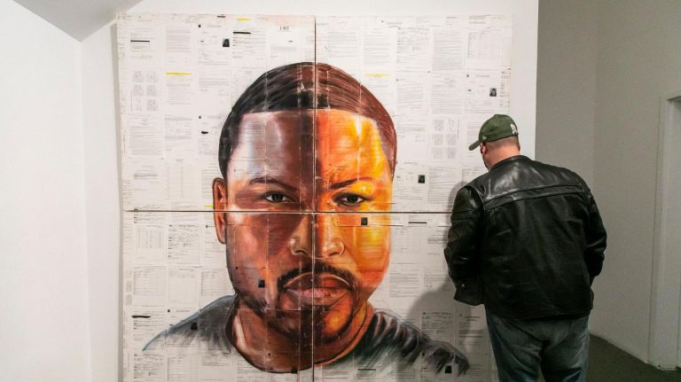 Ex-prisoners speak their truths through art in the 'O.G. Experience' 5 Gilberto Rivera of the Bronx views the work by Russell Craig, "Self-Portrait," at the opening reception.