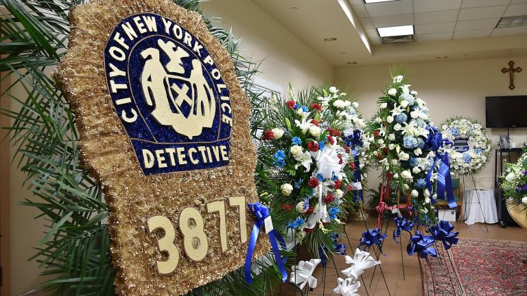 Flowers for the wake of NYPD Det. Brian Simonsen on display at the Church of St. Rosalie in Hampton Bays on Monday.