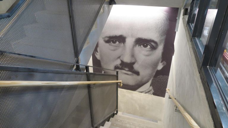 The Center for Fiction's stairwell is decorated with the faces of famous authors and storytellers.